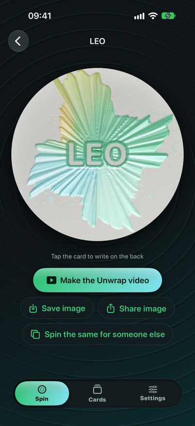 A finished card with the name LEO pressed into green and turquoise spun paint